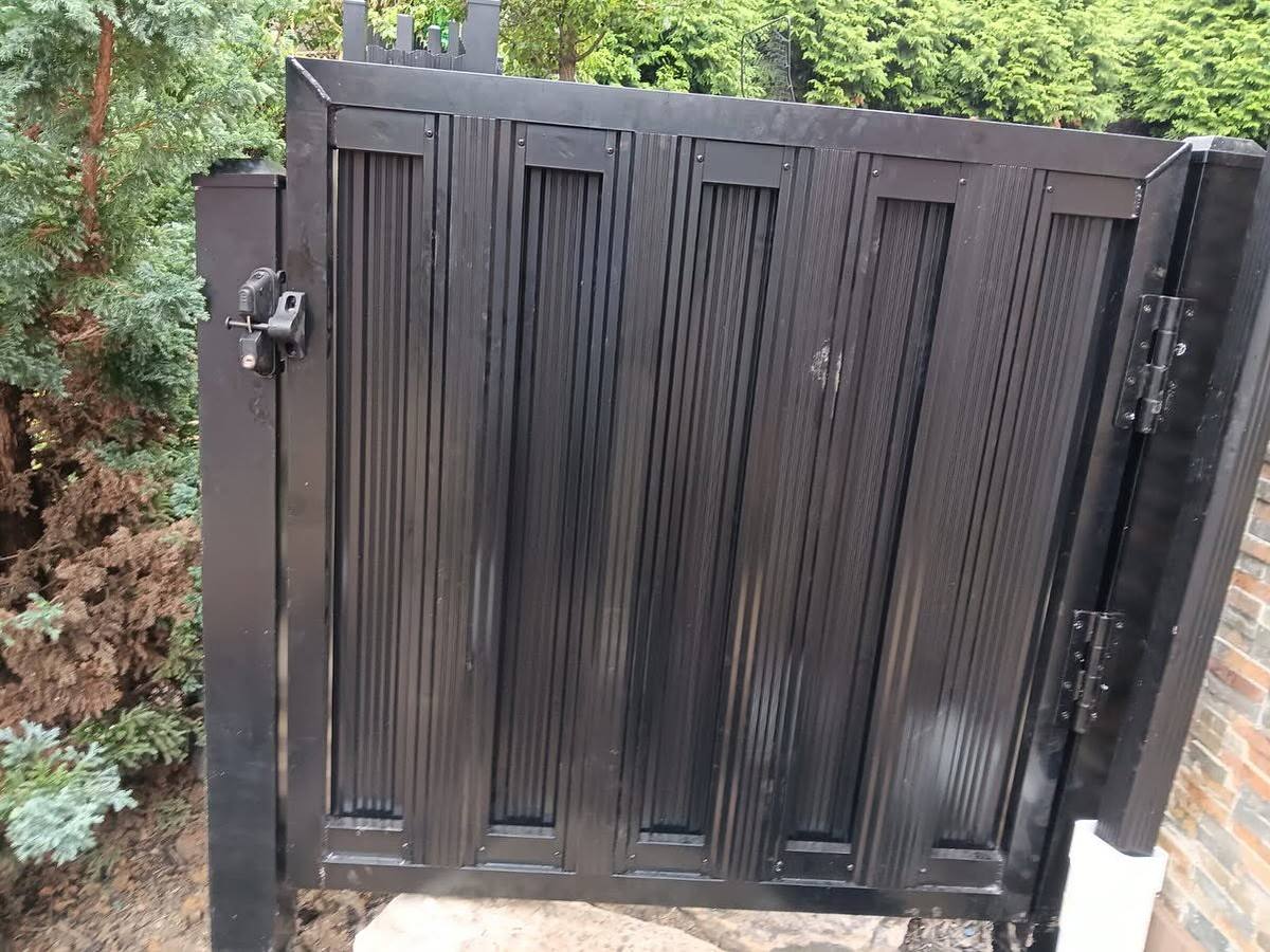 Custom black wood gate with hardware, built to fit the opening