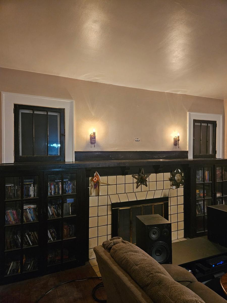 Freshly painted living room with a tiled fireplace and built-in bookshelves